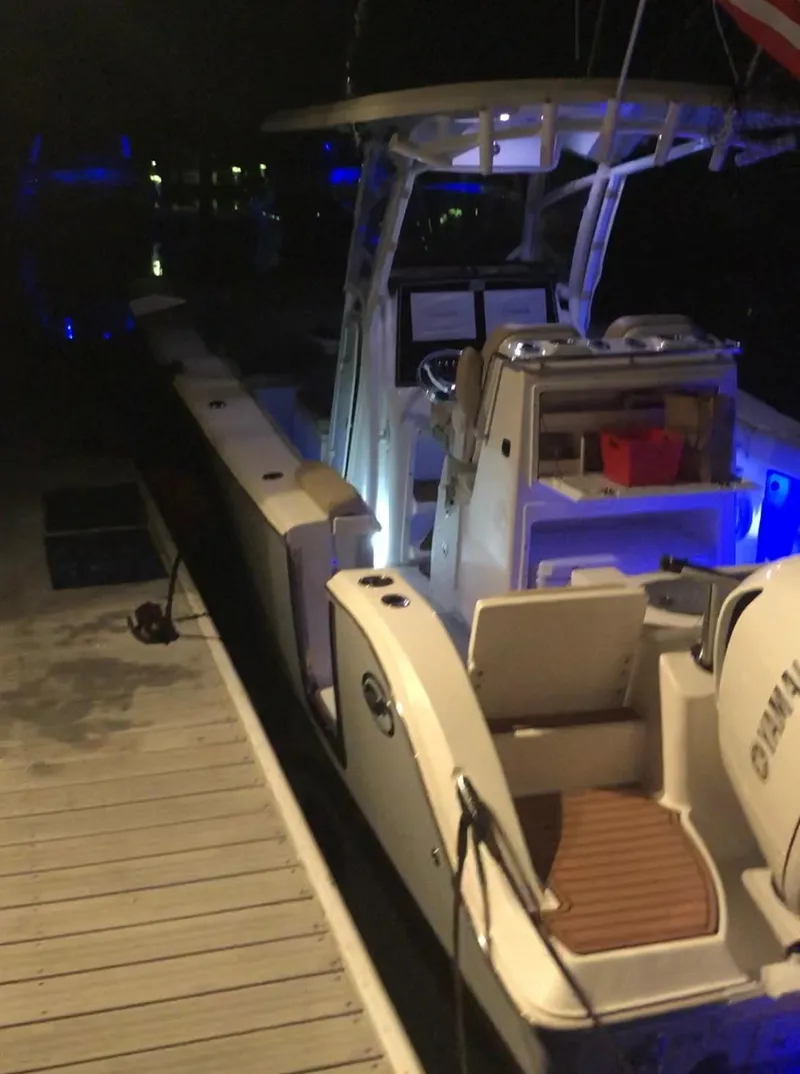 Slide: The Image of 2017 Sea Fox 288 Commander boat docked at night with illuminated interior. - 31