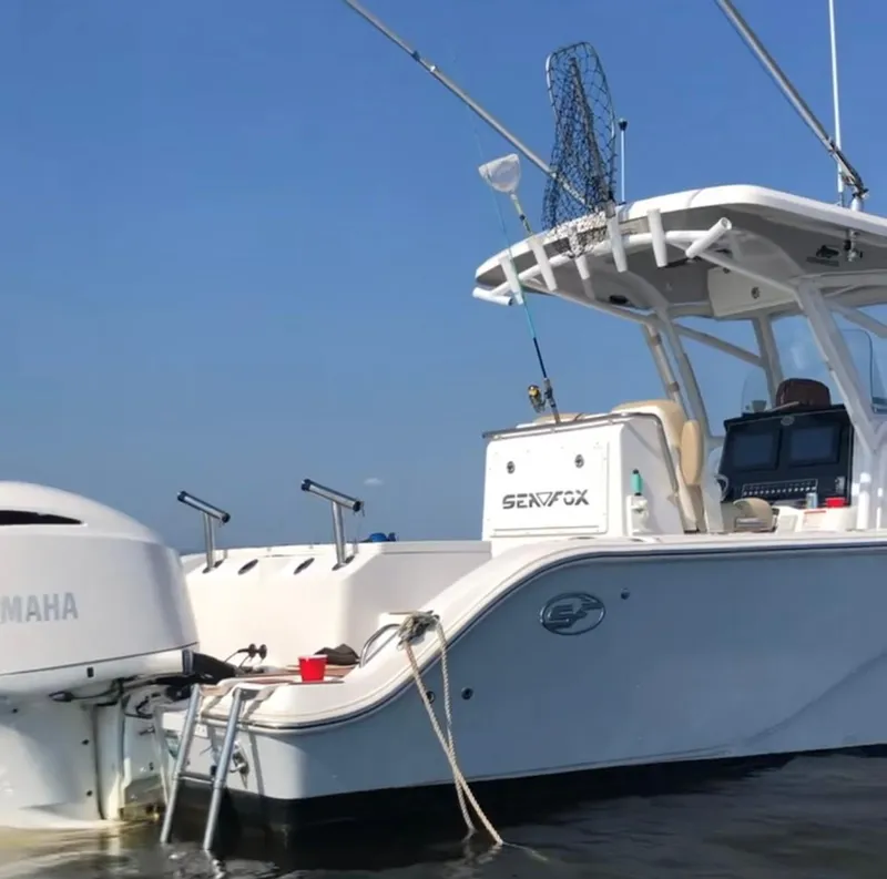 Slide: The Image of 2017 Sea Fox 288 Commander boat on water, featuring Yamaha engine and fishing equipment. - 34