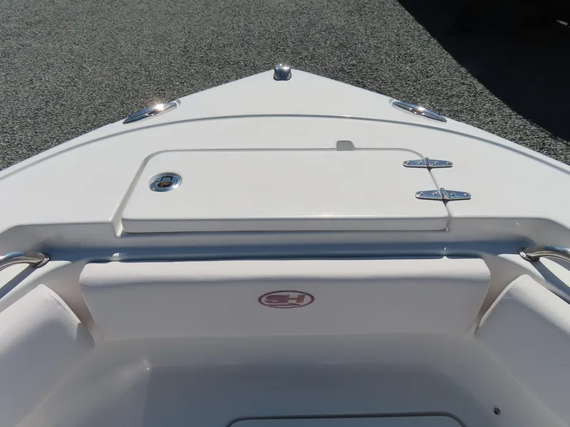 Slide: The Image of Bow view of 2021 Sea Hunt Ultra 219 boat, featuring sleek design and storage compartment. - 12