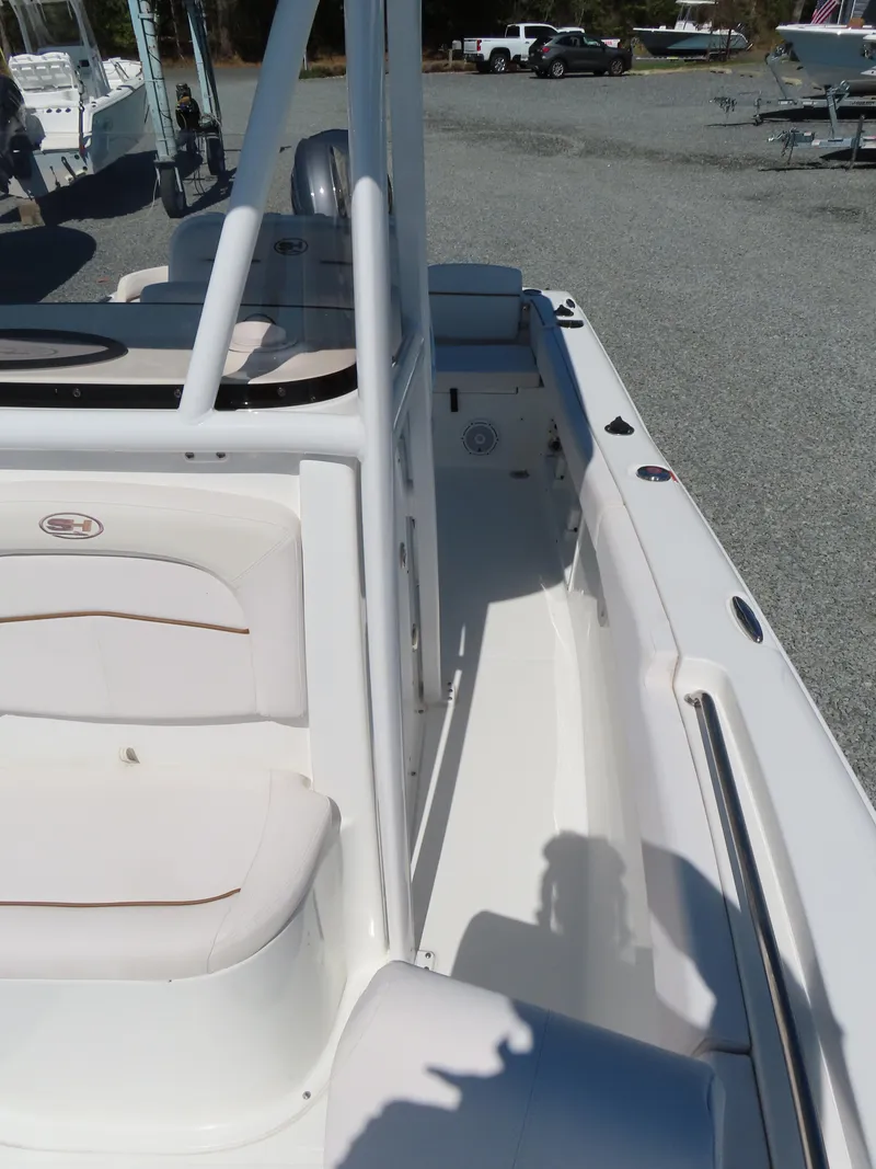 Slide: The Image of 2021 Sea Hunt Ultra 219 boat interior with seating and deck view. - 16