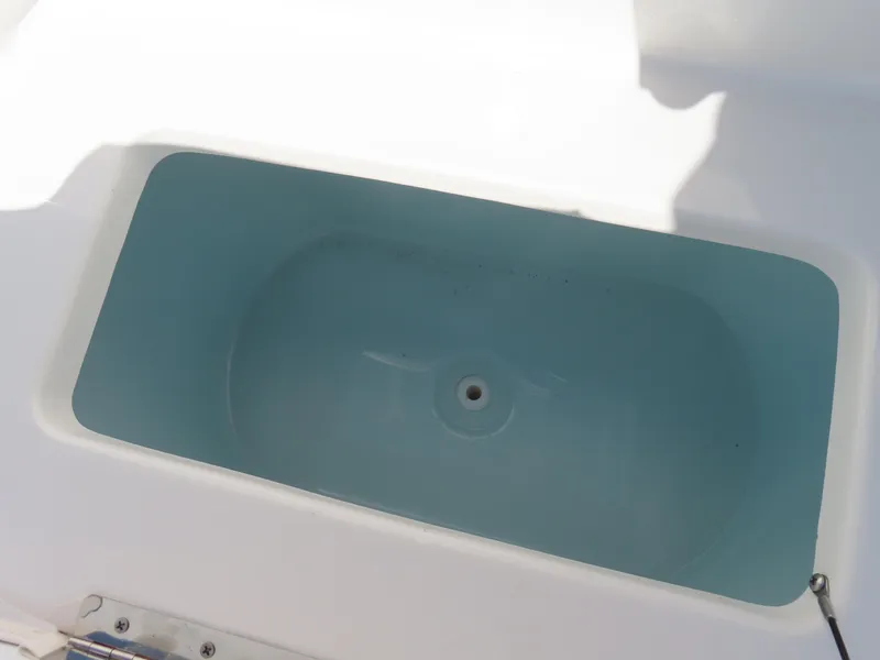 Slide: The Image of Livewell on 2021 Sea Hunt Ultra 219 boat, white interior, blue water. - 18