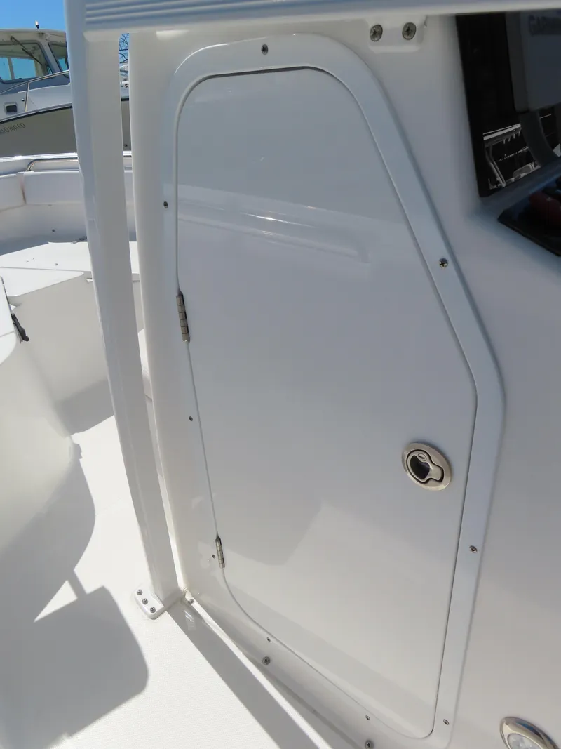 Slide: The Image of 2021 Sea Hunt Ultra 219 boat console door, white finish, sleek design. - 19