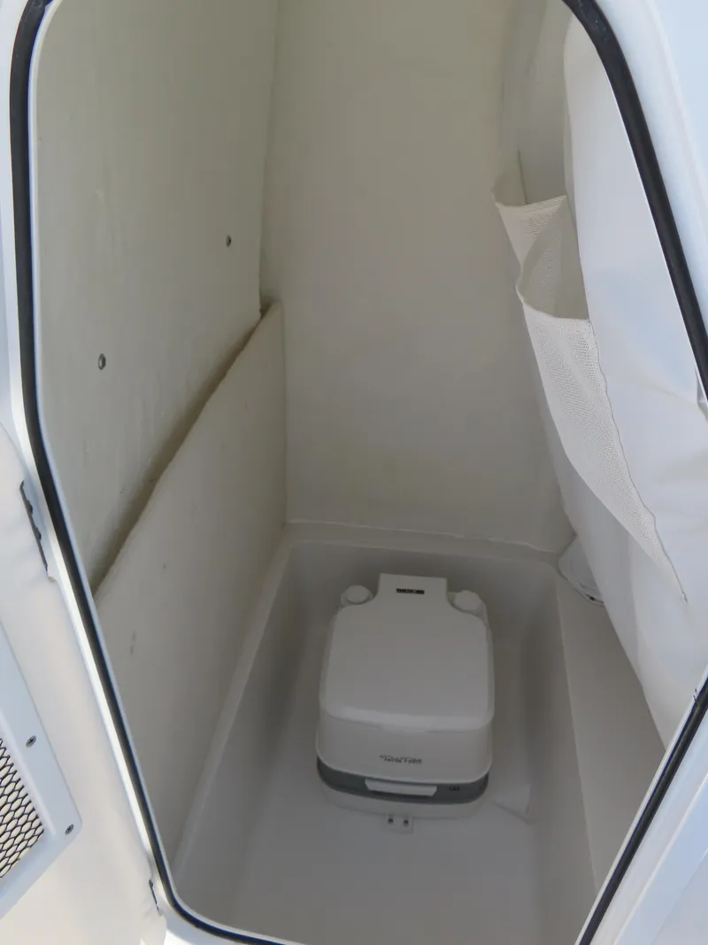 Slide: The Image of 2021 Sea Hunt Ultra 219 boat interior with portable toilet. - 20