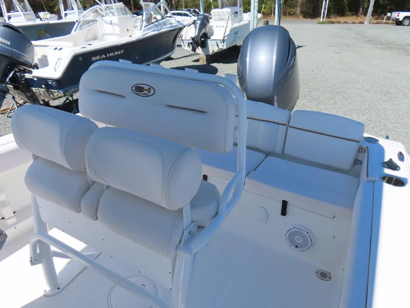 Slide: The Image of 2021 Sea Hunt Ultra 219 boat interior with seating and motor. - 21