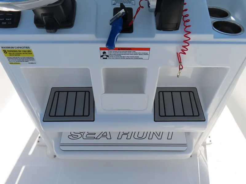 Slide: The Image of 2021 Sea Hunt Ultra 219 boat console with controls and branding. - 26
