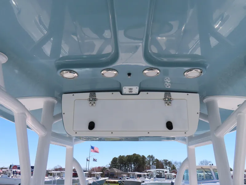 Slide: The Image of 2021 Sea Hunt Ultra 219 boat T-top with speakers and storage compartment. - 27