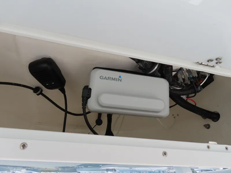 Slide: The Image of Garmin device installed on 2021 Sea Hunt Ultra 219 boat, featuring wiring and microphone. - 28