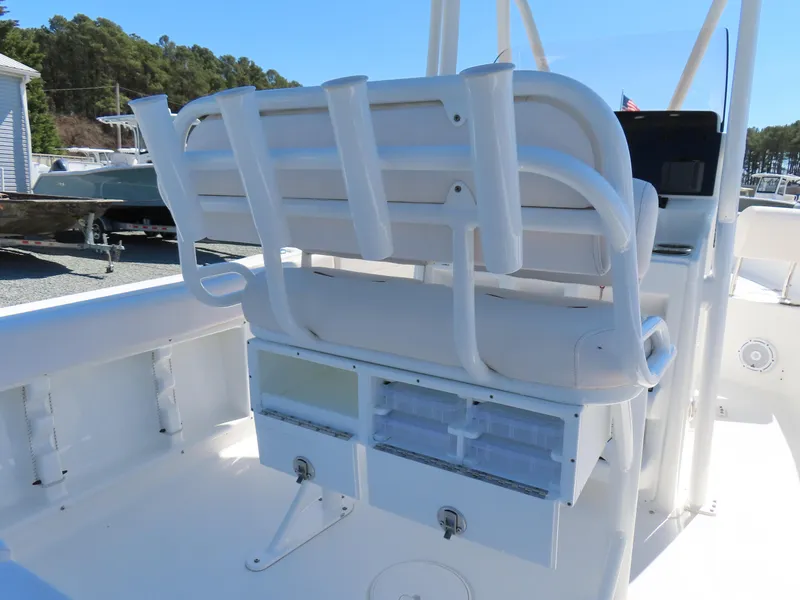 Slide: The Image of 2021 Sea Hunt Ultra 219 boat interior with white seating and storage compartments. - 31