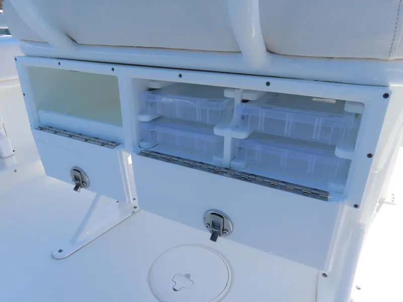 Slide: The Image of Storage compartments on a 2021 Sea Hunt Ultra 219 boat, featuring organized tackle boxes. - 32