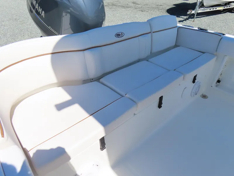Slide: The Image of 2021 Sea Hunt Ultra 219 boat with white cushioned seating and Yamaha engine. - 33