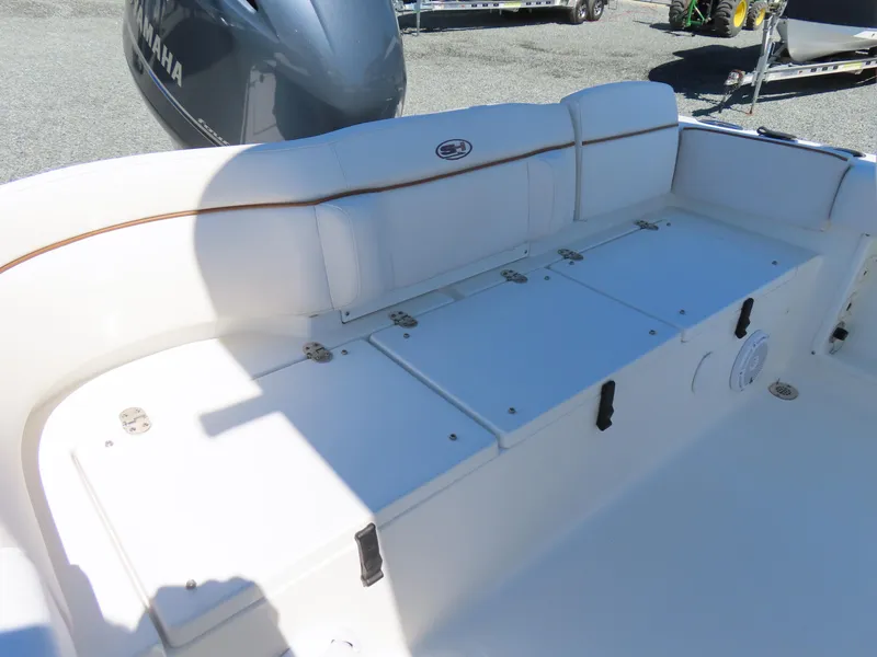 Slide: The Image of 2021 Sea Hunt Ultra 219 boat seating area with storage compartments. - 34