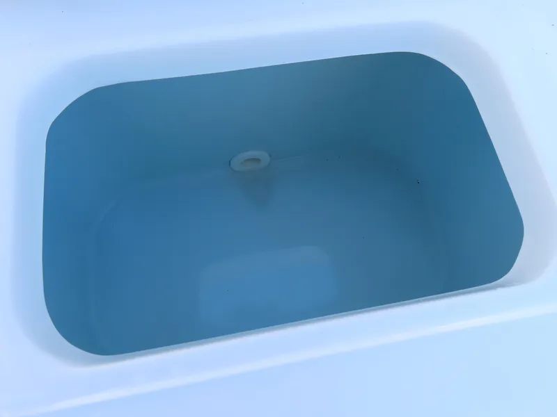 Slide: The Image of Livewell in 2021 Sea Hunt Ultra 219 boat, featuring a clean, blue interior. - 37