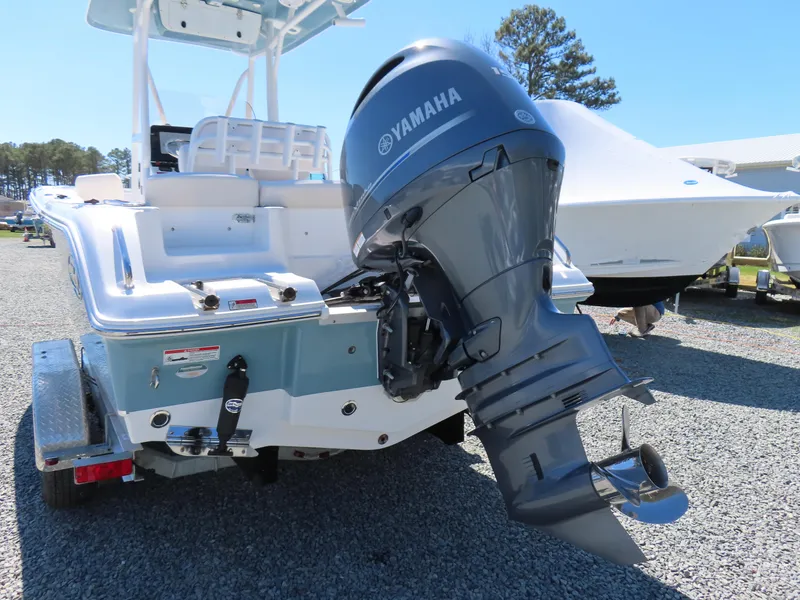 Slide: The Image of 2021 Sea Hunt Ultra 219 boat with Yamaha outboard motor, parked on gravel. - 4