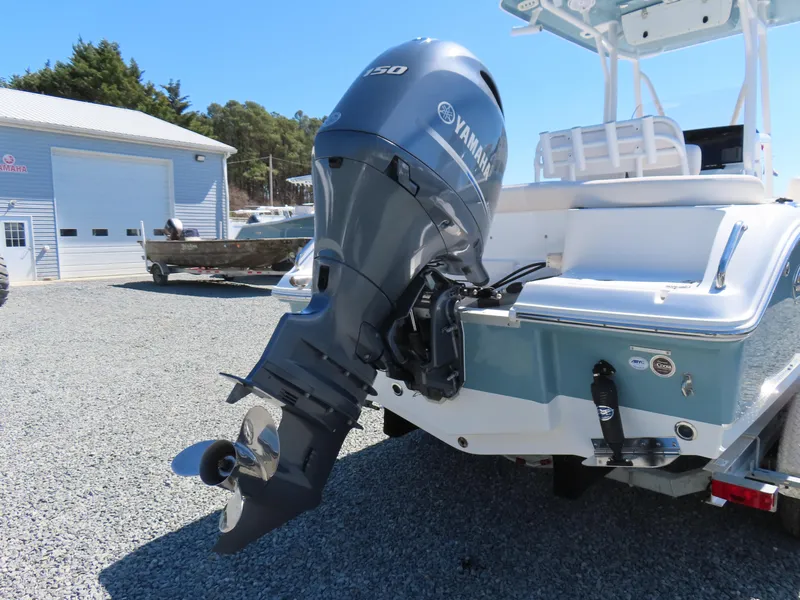 Slide: The Image of 2021 Sea Hunt Ultra 219 boat with Yamaha outboard motor in a marina setting. - 5