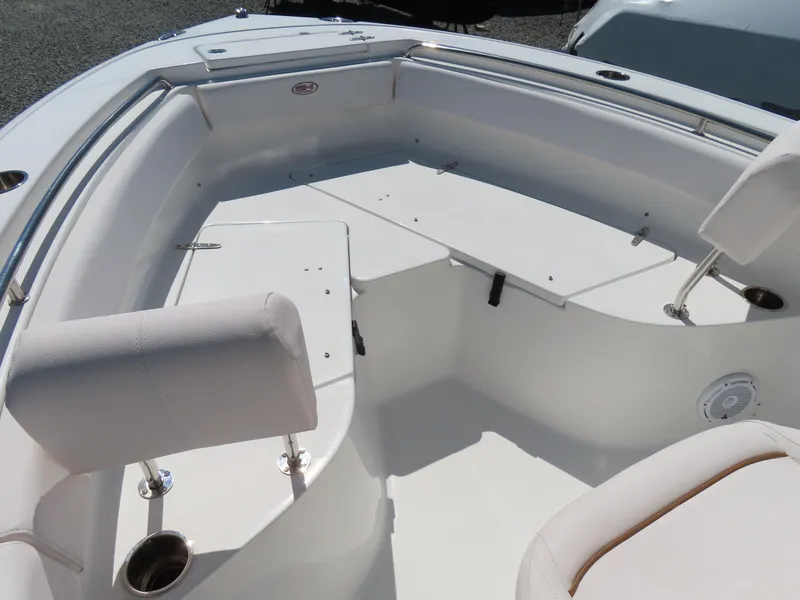 Slide: The Image of 2021 Sea Hunt Ultra 219 boat interior with white seating and stainless steel fixtures. - 8