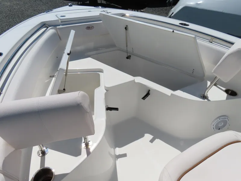 Slide: The Image of 2021 Sea Hunt Ultra 219 boat interior with open storage compartments and seating. - 9
