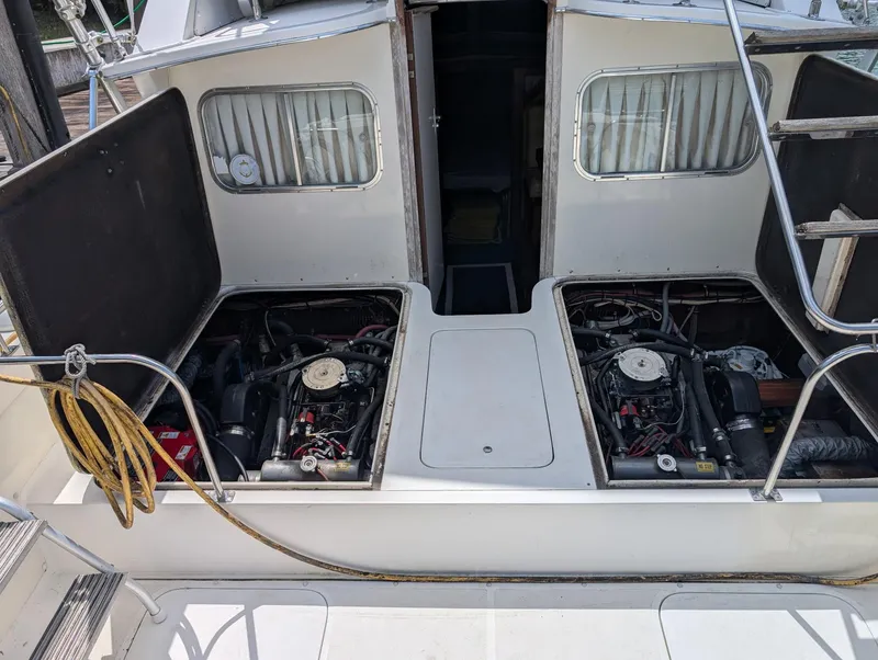 Slide: The Image of 1979 Bertram 28 Flybridge Cruiser engine compartment with dual engines visible. - 11