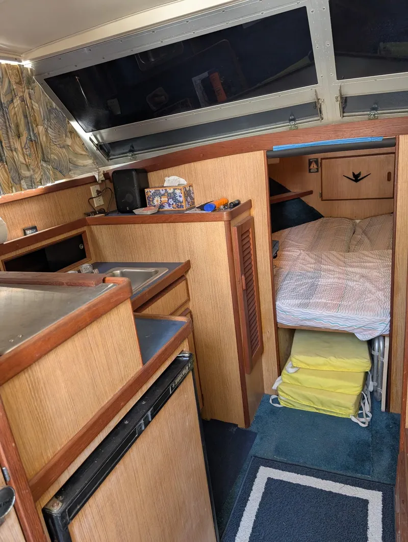 Slide: The Image of 1979 Bertram 28 Flybridge Cruiser interior with kitchenette and cozy sleeping area. - 3