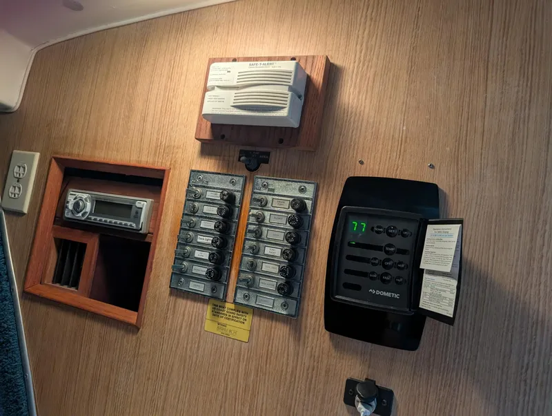 Slide: The Image of Control panel of a 1979 Bertram 28 Flybridge Cruiser with switches and electronic devices. - 8