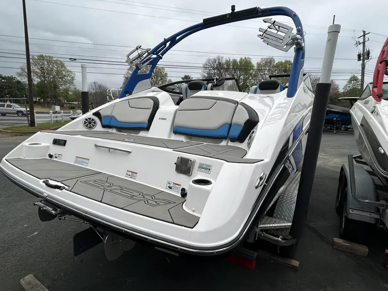Slide: The Image of 2019 Yamaha Boats 212X with sleek design and comfortable seating, displayed outdoors. - 4