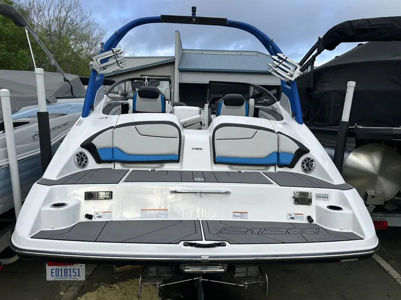 Slide: The Image of 2019 Yamaha Boats 212X, rear view, showcasing sleek design and seating arrangement. - 5