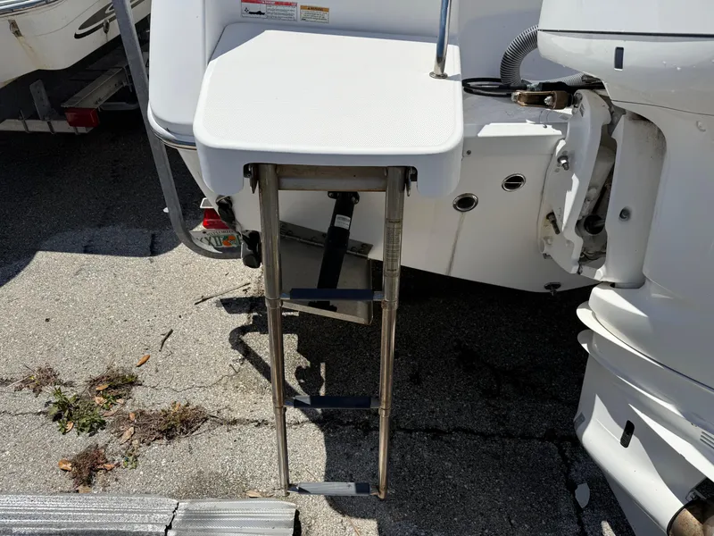 Slide: The Image of 2018 Everglades 230 Center Console boat with foldable swim ladder. - 11