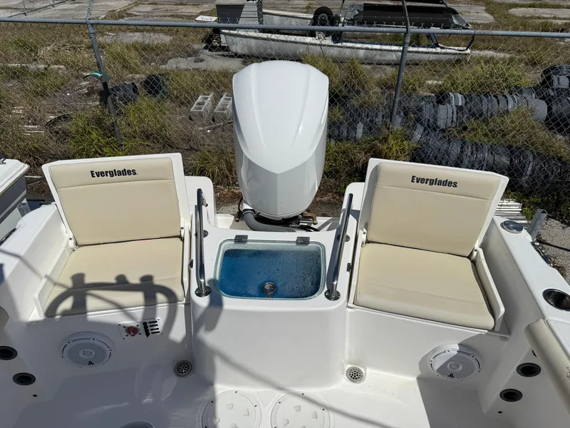 Slide: The Image of 2018 Everglades 230 Center Console boat interior with seating and engine view. - 15