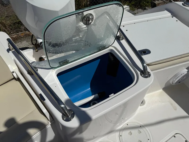 Slide: The Image of Open storage compartment on 2018 Everglades 230 Center Console boat. - 16