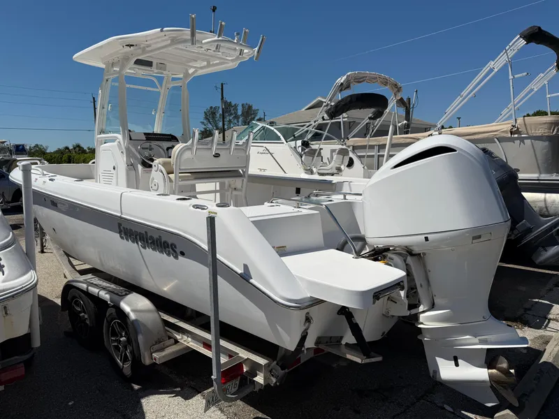 Slide: The Image of 2018 Everglades 230 Center Console boat on trailer, parked in marina. - 2