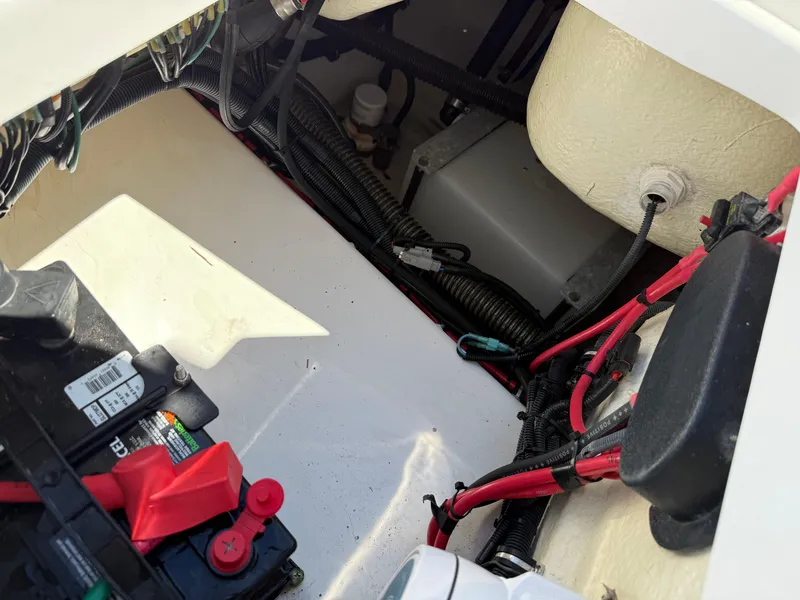 Slide: The Image of Battery compartment of a 2018 Everglades 230 Center Console boat, showing wiring and components. - 26