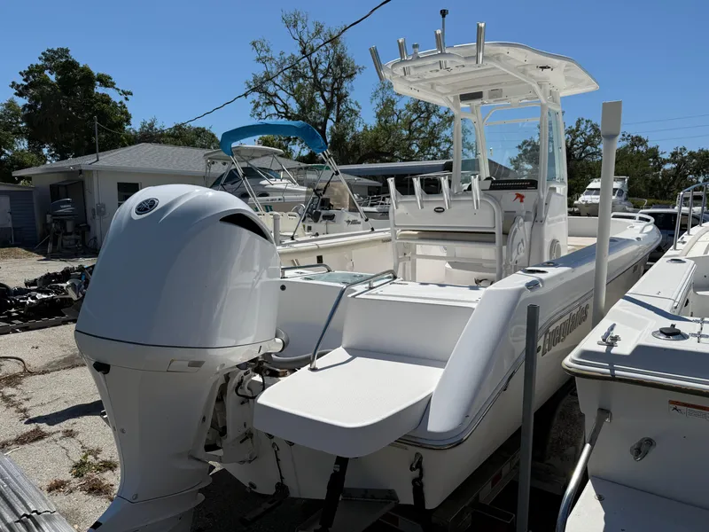Slide: The Image of 2018 Everglades 230 Center Console boat with outboard motor, docked outdoors. - 3