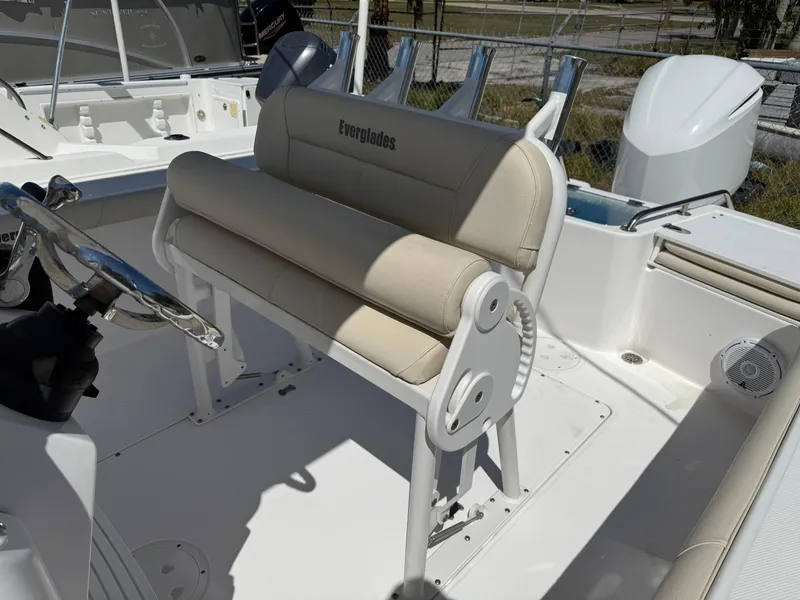 Slide: The Image of 2018 Everglades 230 Center Console boat interior with beige seating and steering wheel. - 31