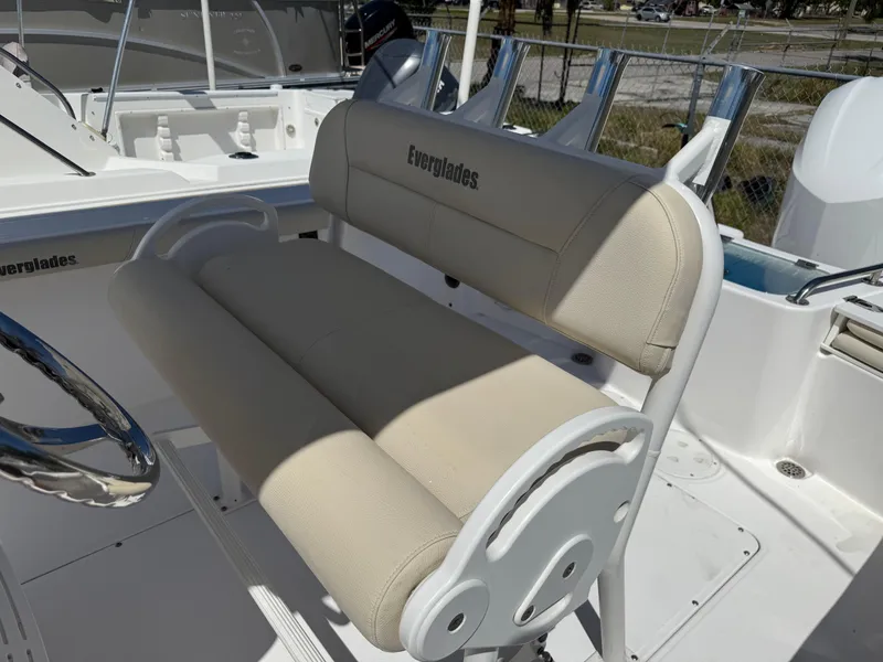 Slide: The Image of 2018 Everglades 230 Center Console boat with beige seating and rod holders. - 32