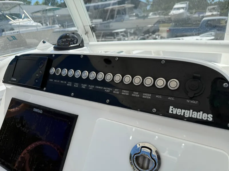 Slide: The Image of Control panel of a 2018 Everglades 230 Center Console boat with various switches and gauges. - 37