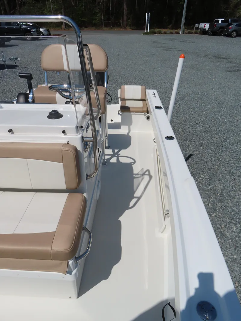 Slide: The Image of 2018 Parker 1801 Center Console boat with beige seating, parked on gravel. - 15