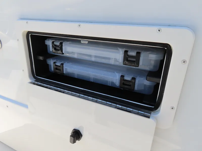 Slide: The Image of Storage compartment on a 2018 Parker 1801 Center Console boat with tackle boxes. - 19