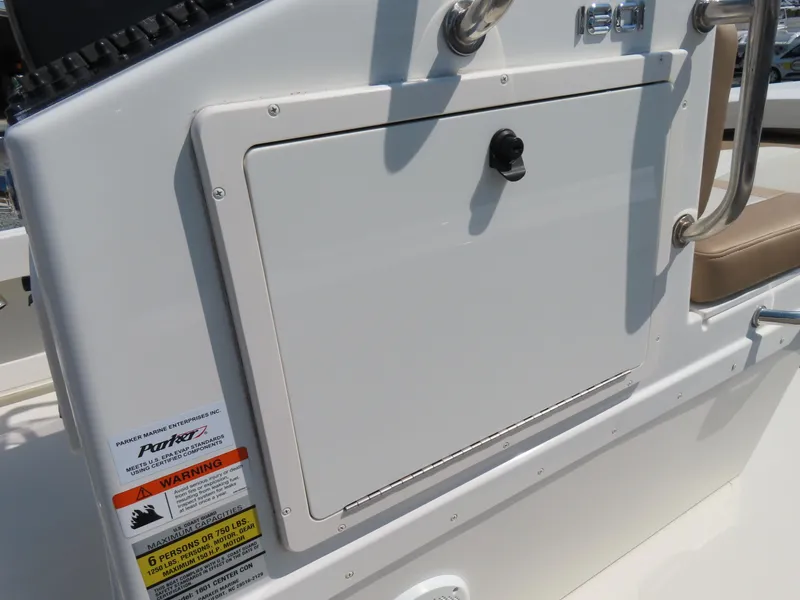 Slide: The Image of 2018 Parker 1801 Center Console boat dashboard with storage compartment and safety labels. - 20