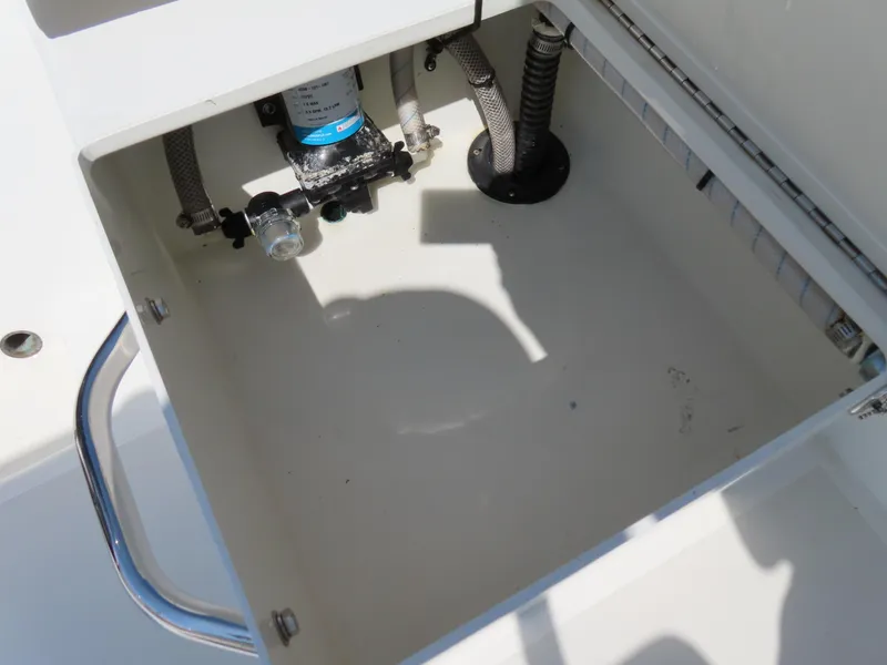 Slide: The Image of Open storage compartment in 2018 Parker 1801 Center Console boat, showing internal components. - 29