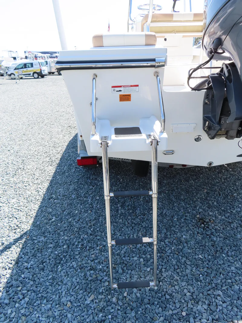 Slide: The Image of 2018 Parker 1801 Center Console boat with rear ladder on gravel surface. - 6
