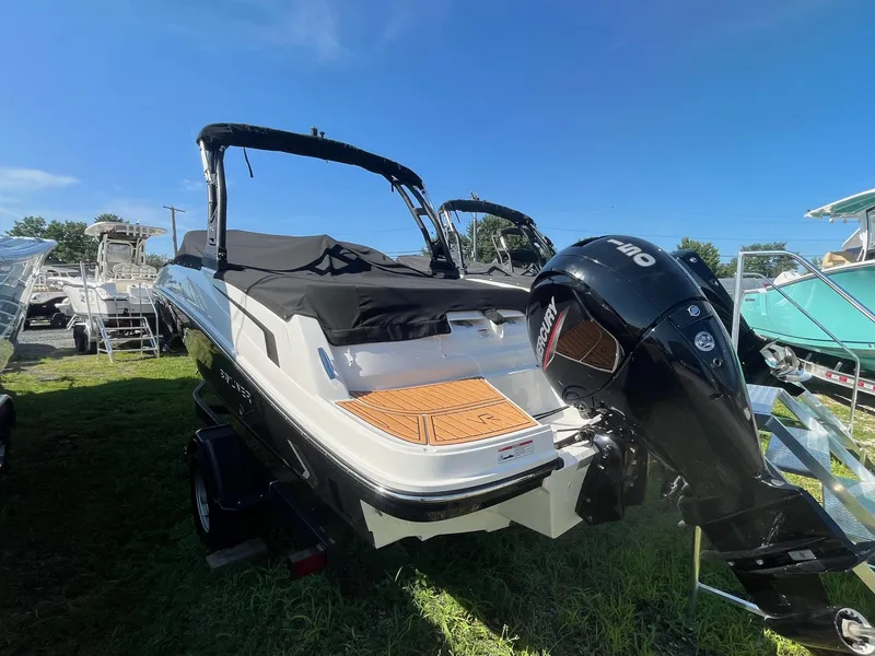 Slide: The Image of 2025 Bayliner VR5 Bowrider OB with Mercury outboard engine, parked on grass. - 13