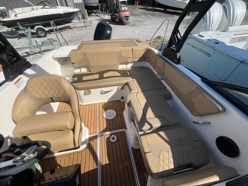 Slide: The Image of 2025 Bayliner VR5 Bowrider OB interior with tan seating and wood flooring. - 15