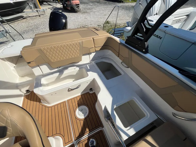 Slide: The Image of 2025 Bayliner VR5 Bowrider OB interior with tan seating and storage compartments. - 16