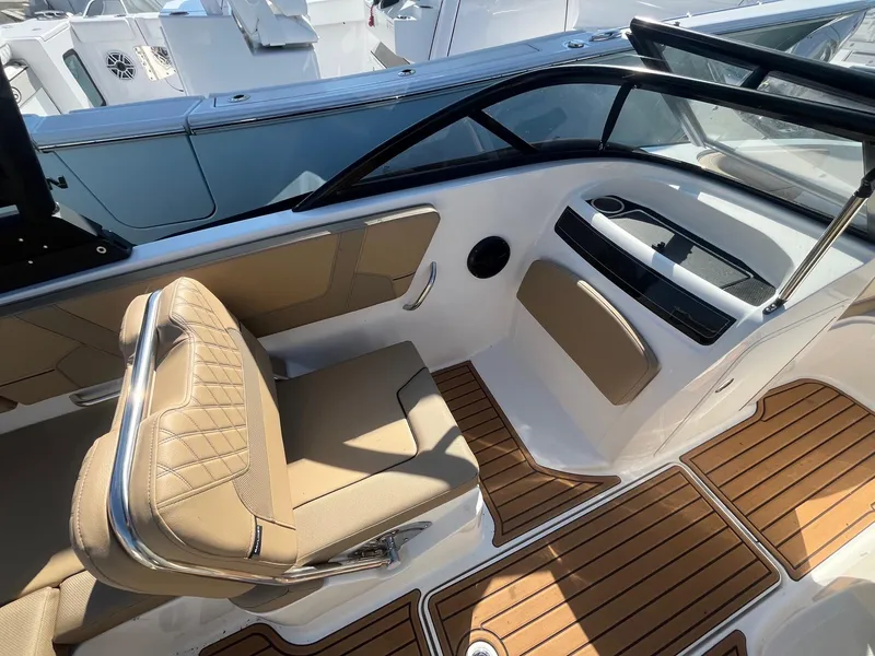 Slide: The Image of 2025 Bayliner VR5 Bowrider OB interior with tan seating and wood-style flooring. - 19