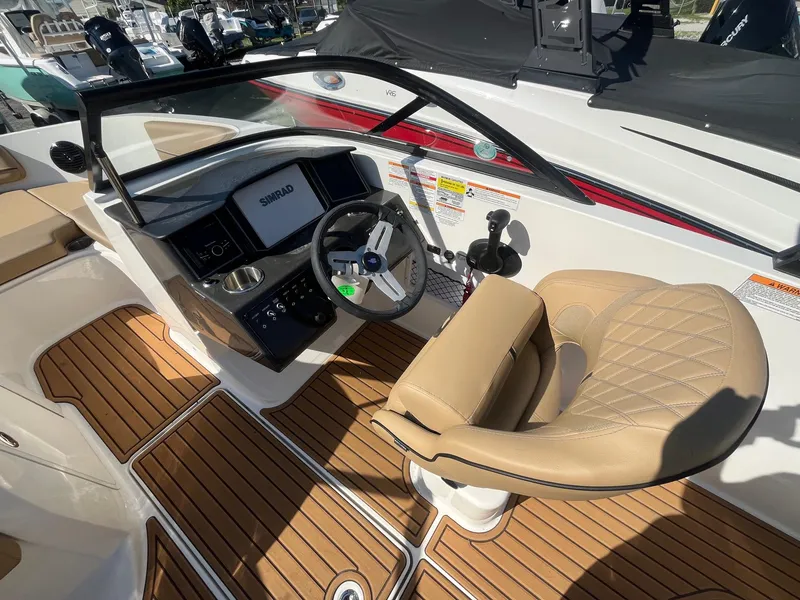 Slide: The Image of 2025 Bayliner VR5 Bowrider OB cockpit with tan seating and modern controls. - 20
