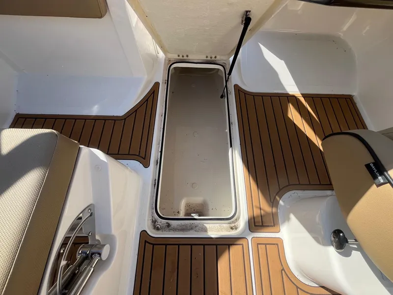 Slide: The Image of 2025 Bayliner VR5 Bowrider OB interior with teak-style flooring and storage compartment. - 21
