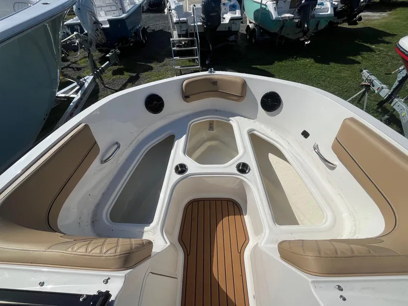 Slide: The Image of 2025 Bayliner VR5 Bowrider OB interior with tan seating and spacious layout. - 25