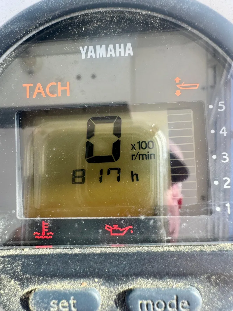 Slide: The Image of Yamaha tachometer displaying 817 hours on a 1998 Regulator 26 Express boat. - 17