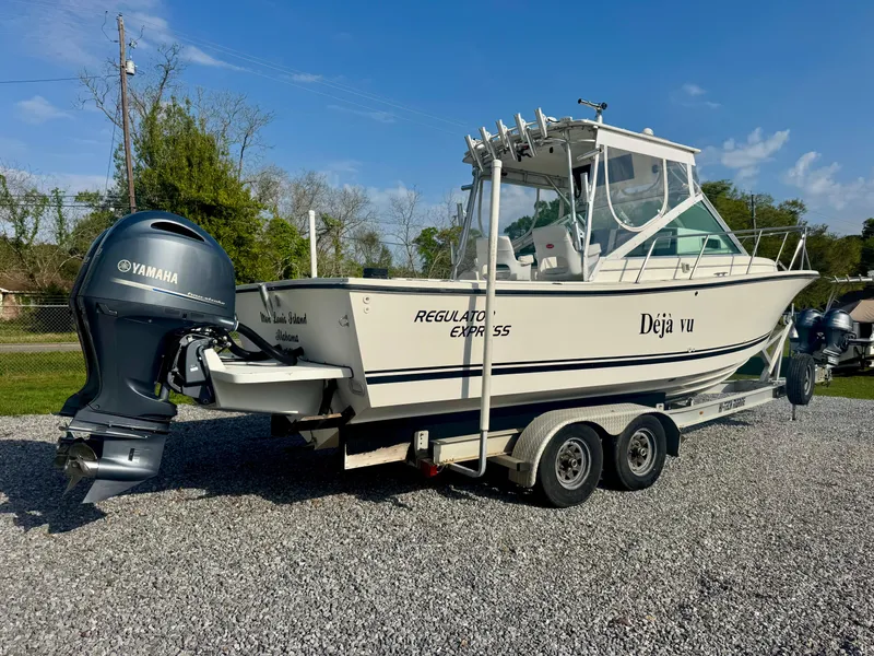 Slide: The Image of 1998 Regulator 26 Express boat on trailer with Yamaha outboard motor. - 3