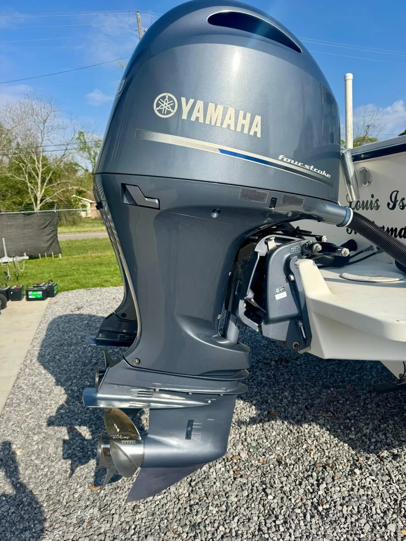 Slide: The Image of Yamaha outboard motor on 1998 Regulator 26 Express boat, parked on gravel. - 4