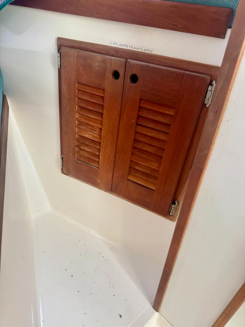 Slide: The Image of Wooden cabinet doors on a 1998 Regulator 26 Express boat interior. - 9